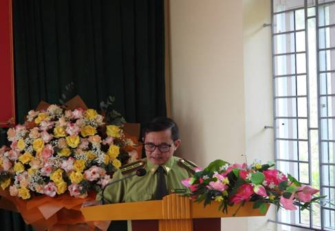 A person in uniform standing at a podium with flowers

AI-generated content may be incorrect.
